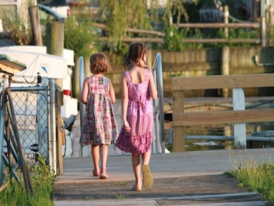 Two girls on boardwalkx